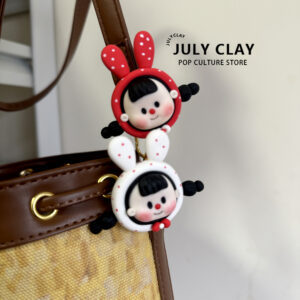 Multi-girl bag with a pendant brooch